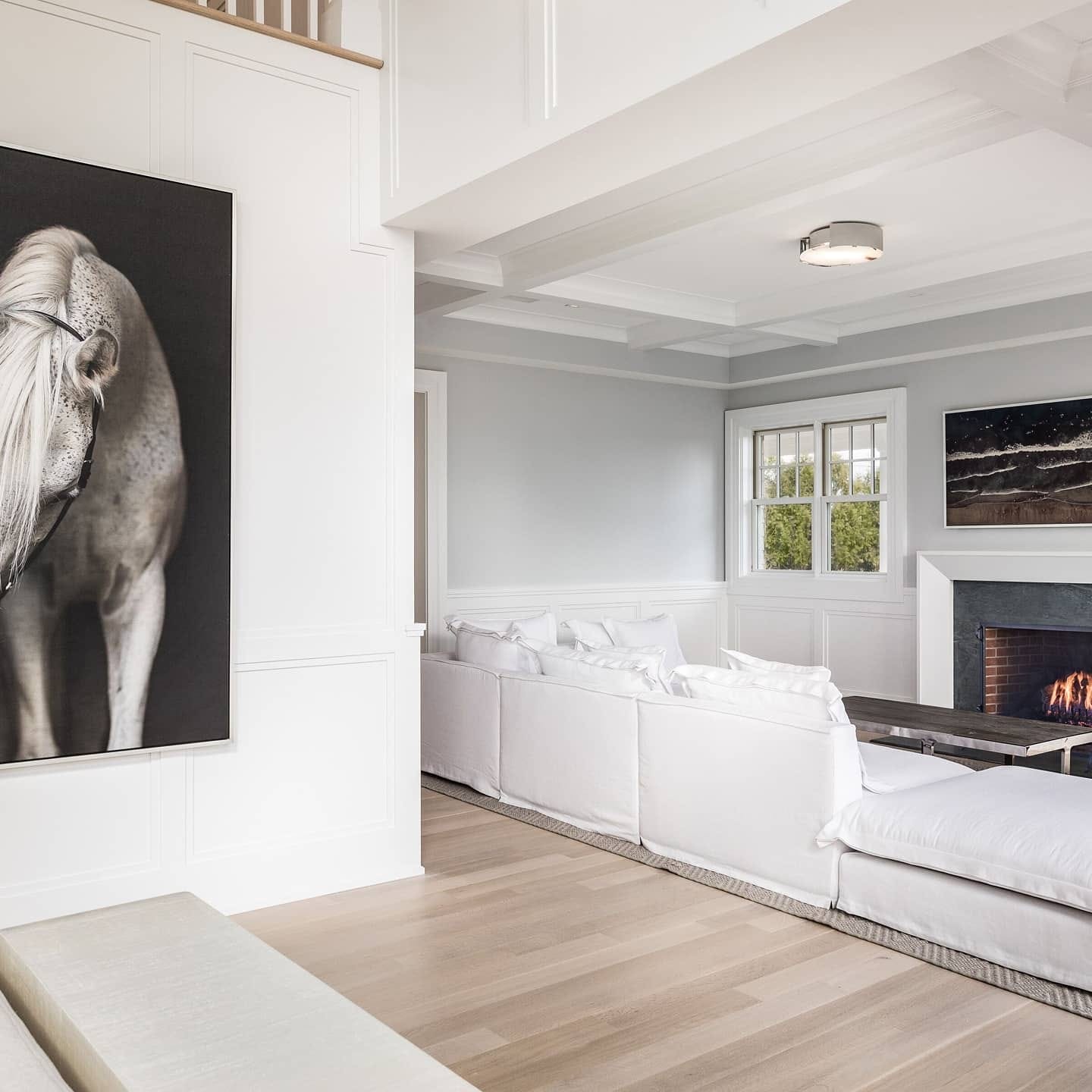 Living room with white panel walls, gray upper walls, and detailed trim work