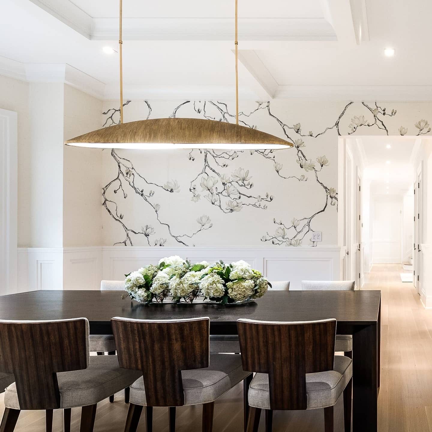 Dining room with white wainscoting and detailed crown molding beneath a coffered ceiling