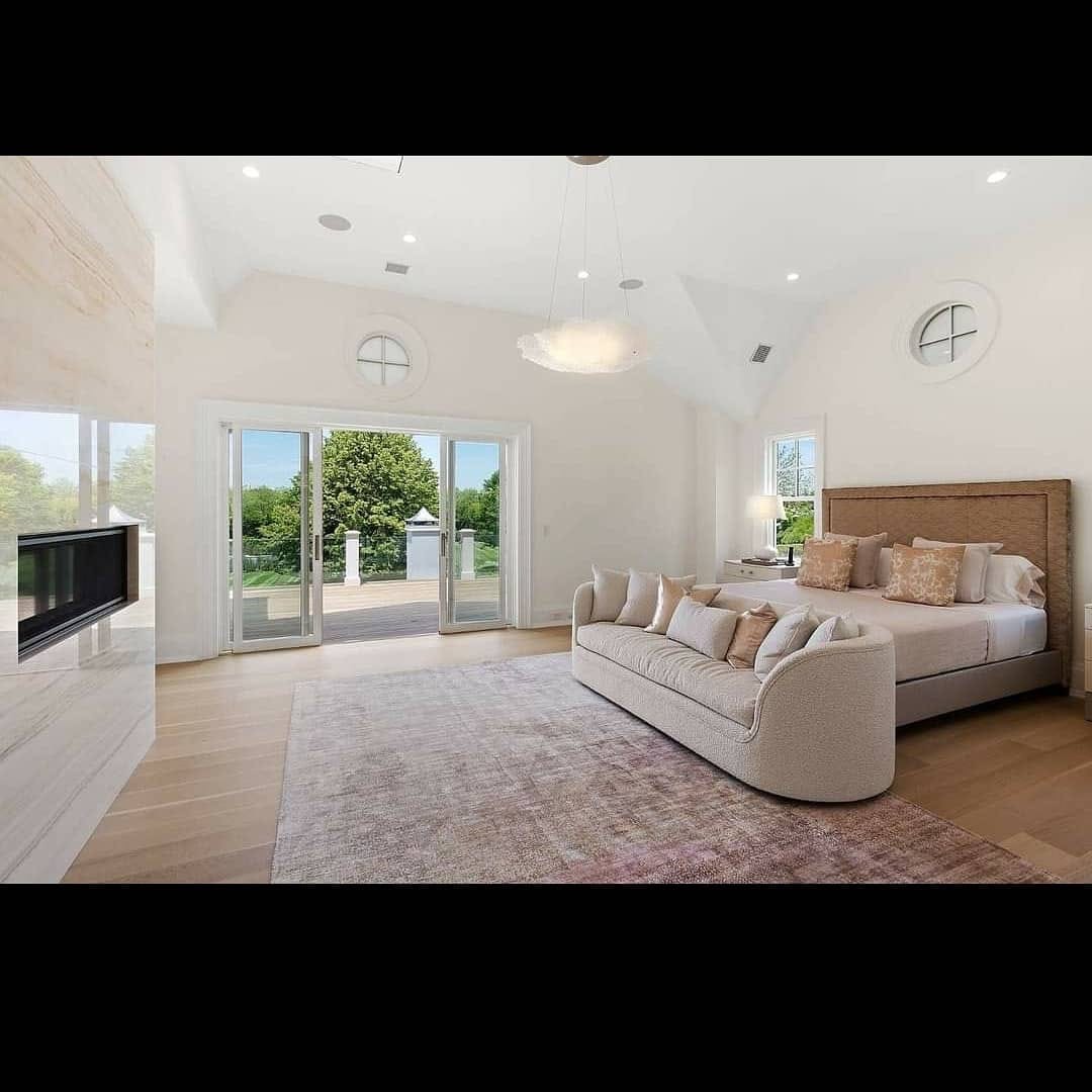 Finished bedroom with vaulted white ceiling and detailed trim